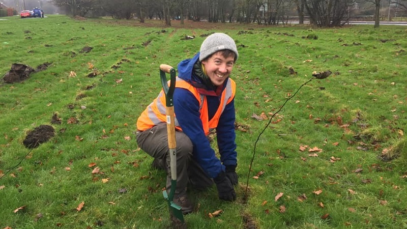 volunteer preparing land for tree planting