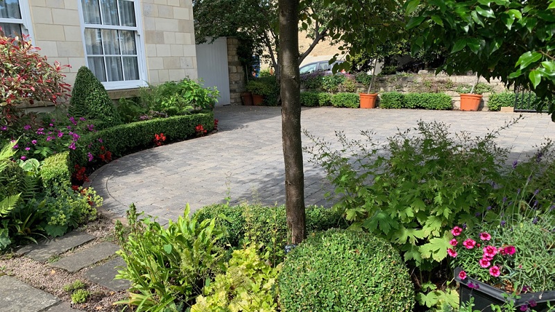 Example of front gardens with driveways and plants